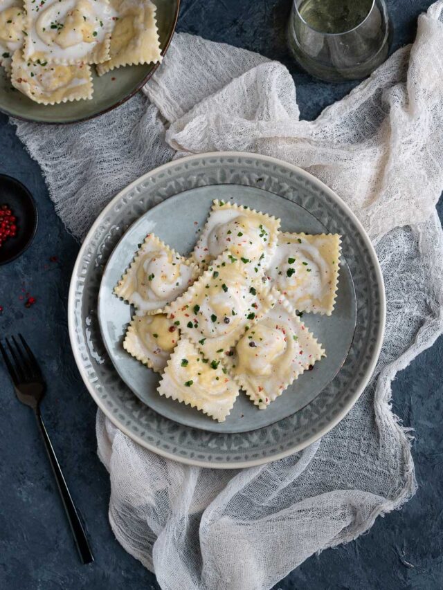 overhead plate with salmon ravioli in cream sauce